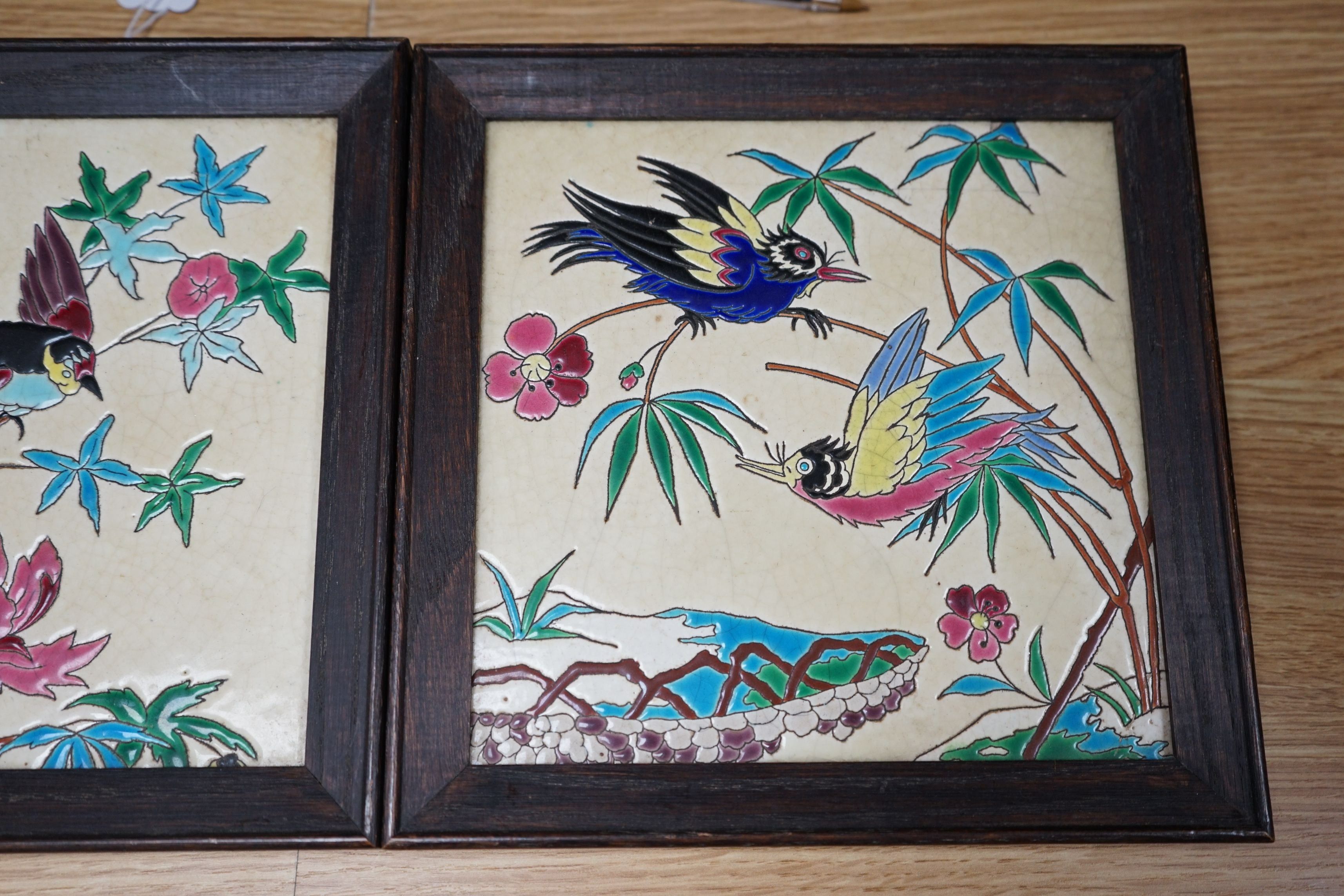 A pair of Longwy framed tiles, 19cms square